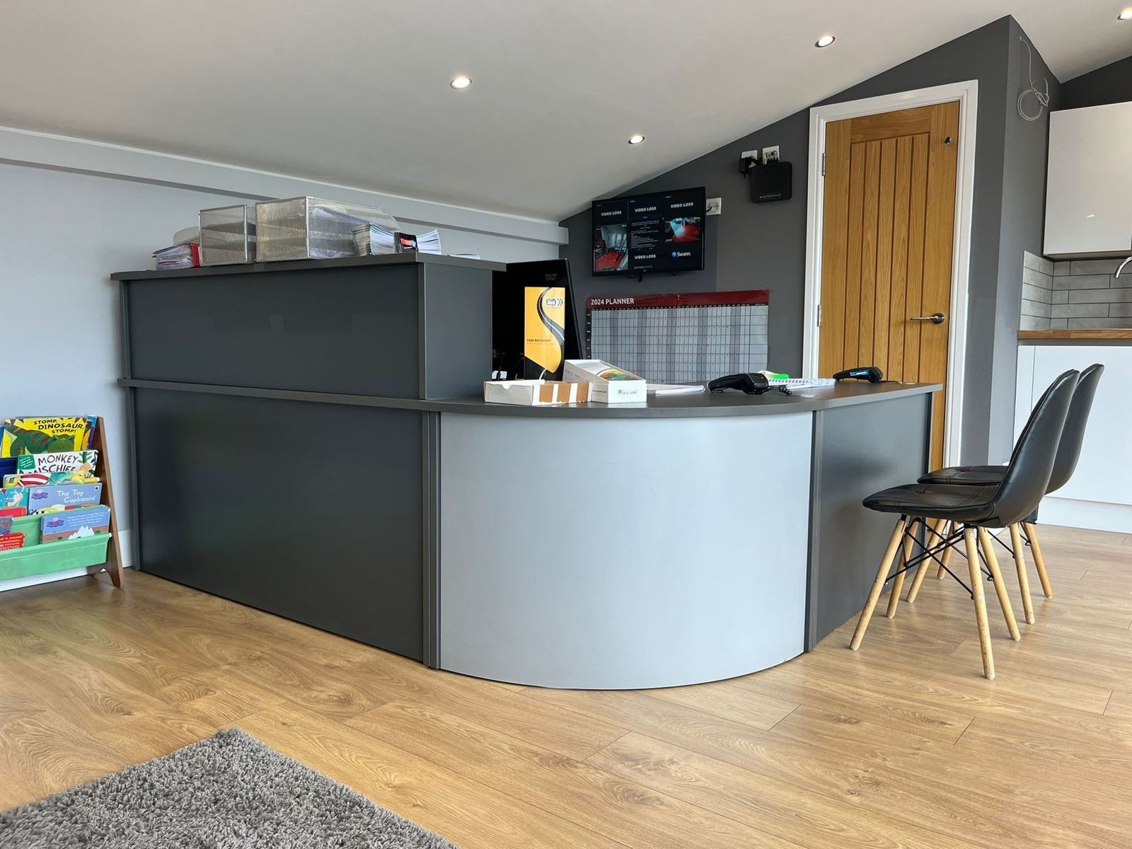 The curved front desk and waiting chairs